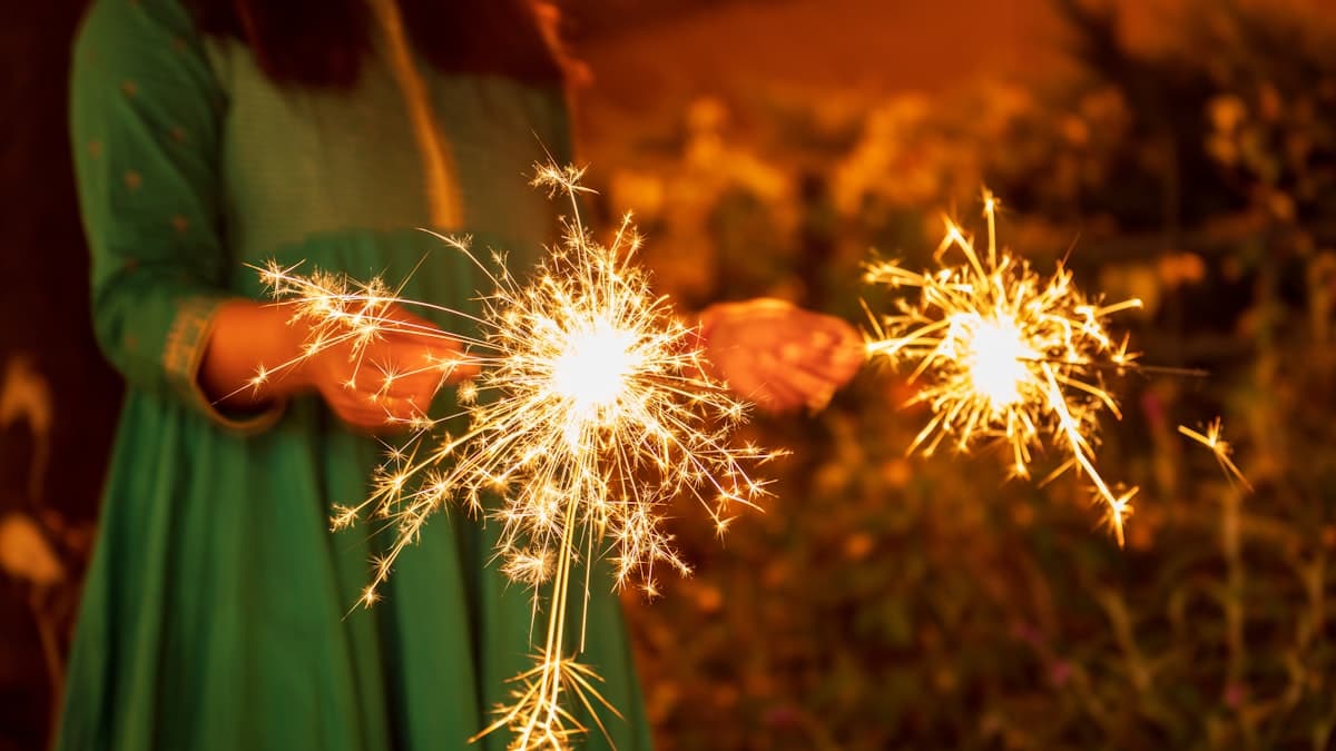 Woman celebrating Tihar with a sparkler