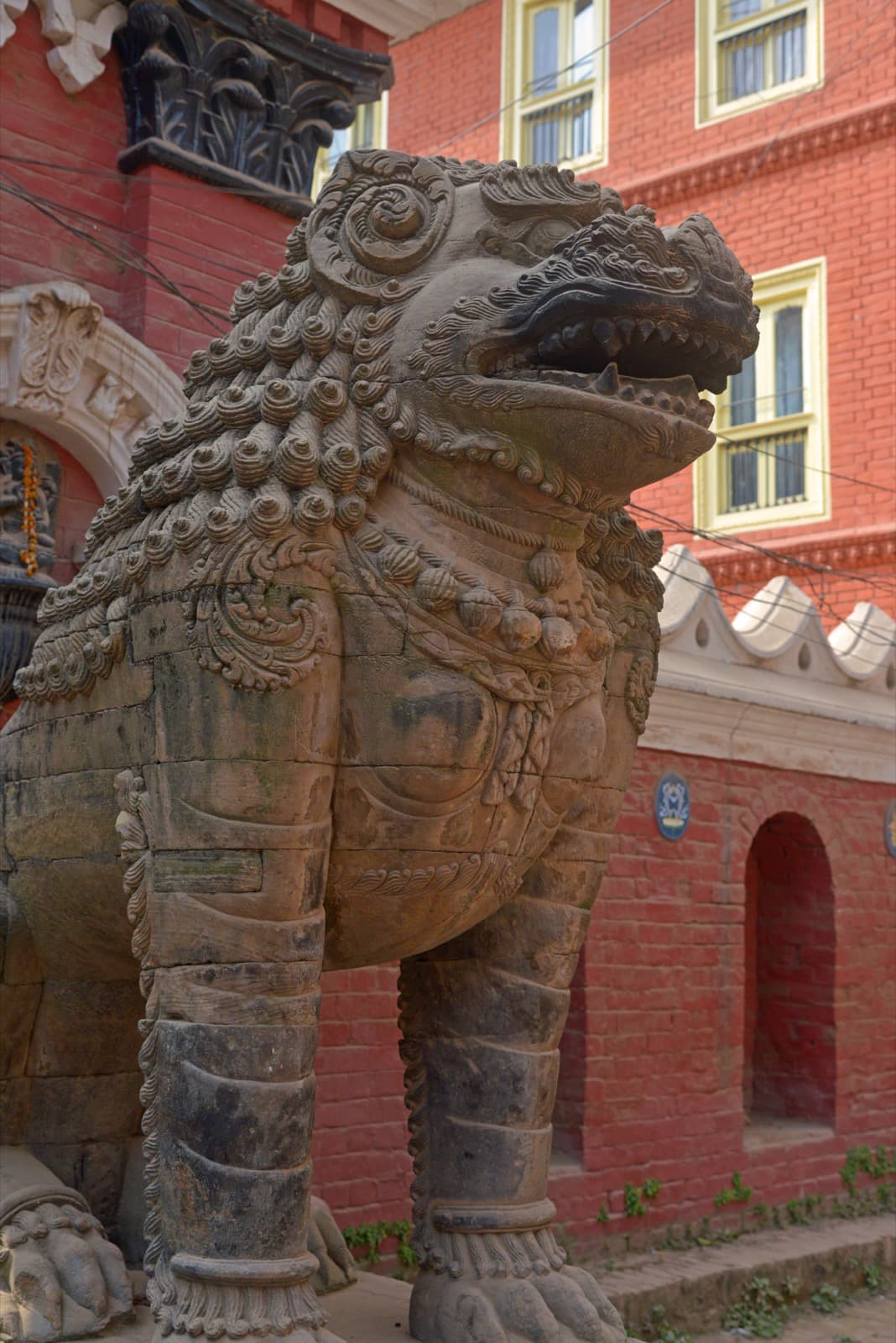 17th-century stone lion guarding the entrance of Rudravarna Mahavihar