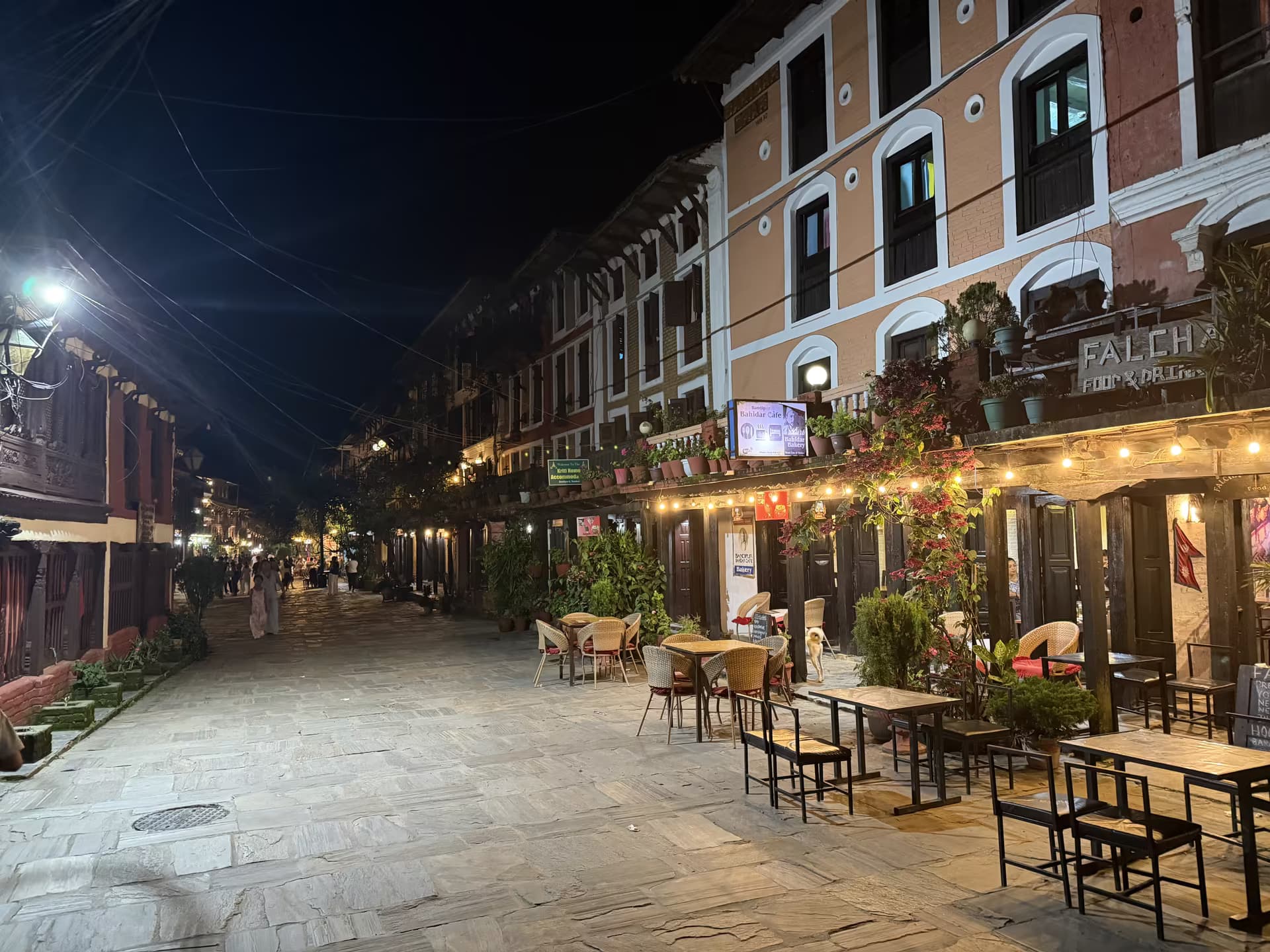Bandipur's pedestrian bazaar at night with cafés and string lights