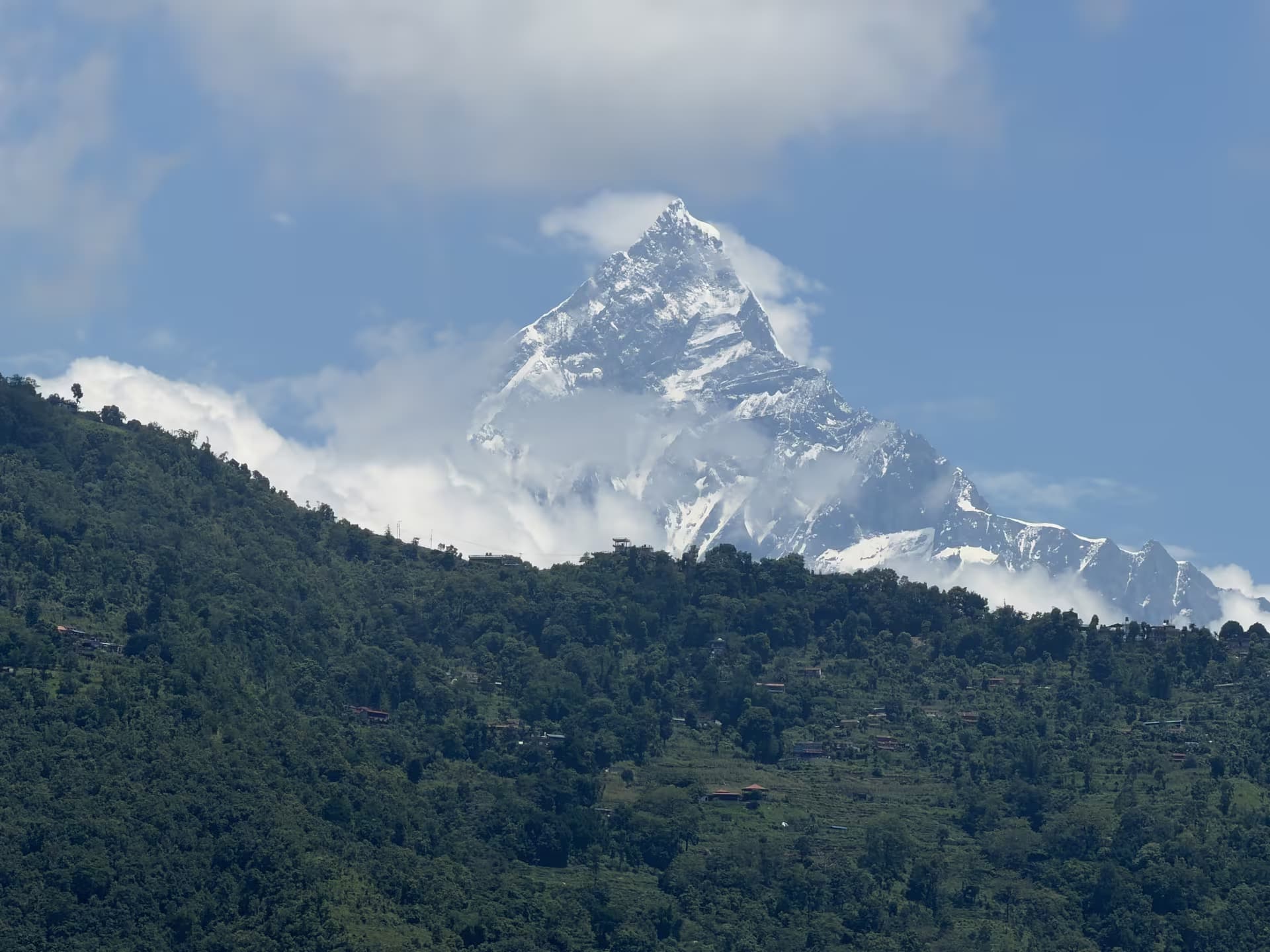 Close view of the snow-capped Machhapuchhre (Fishtail) peak above green foothills
