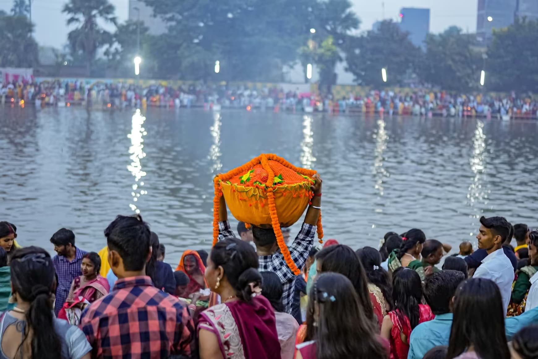 Chhath Puja devotees offering prayers at water